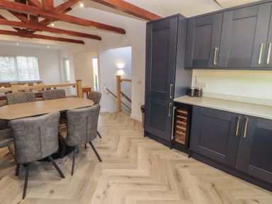 A dining area with a table and chairs at Mallard Cottage in Penrith