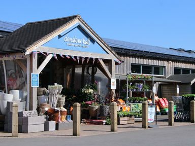 The entrance of a farm shop and cafe with garden supplies and plants on display at No Deer in Ashbourne