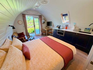 A bedroom with a kitchen area and dining table at No Deer in Ashbourne