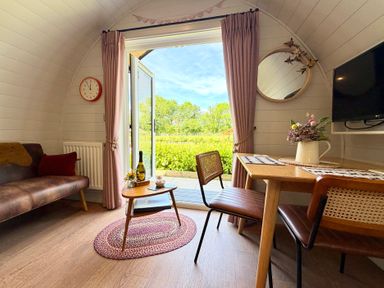 A living area with a sofa and dining table at No Deer in Ashbourne
