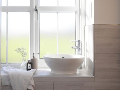 A bathroom sink with a faucet and toiletries on a windowsill at Ash Cottage in Lucker near Warenford