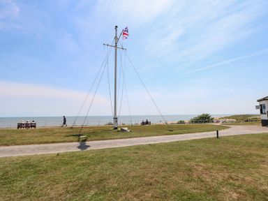 An outdoor area with a flagpole and a view of the sea at Skylark Southwold