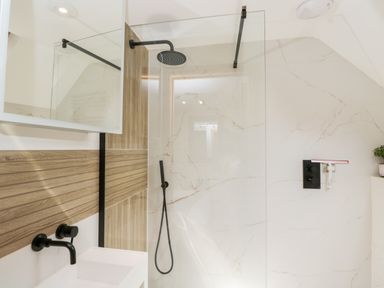 A bathroom with a walk-in shower and a white sink with black fixtures at 2 Dewars Farm Cottages in Middleton Stoney