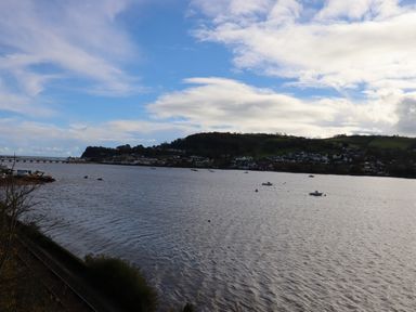 A body of water with boats and hills in the background at Rose Cottage in Bishopsteignton