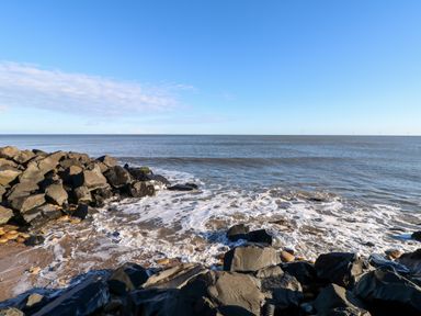 A rocky shoreline with waves coming in at 17 Summer Meadows in Ashington