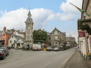 A street view with a clock tower and buildings on either side at Belle Vue in Hay on Wye Herefordshire