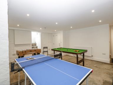 A game room with a blue table tennis table foosball table and snooker table at Belle Vue in Hay on Wye Herefordshire
