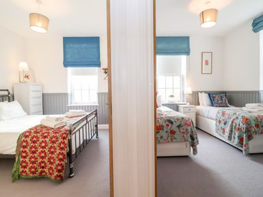 Two bedrooms separated by a wall each with beds lamps and windows with blue blinds at Ebenezer Chapel in Knodishall nr Saxmundham