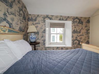 A bedroom with a bed and window at Penvar in Truro