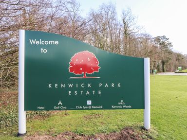 A welcome sign for Kenwick Park Estate on grass with trees in the background at iLodge Ultra Kenwick near Louth