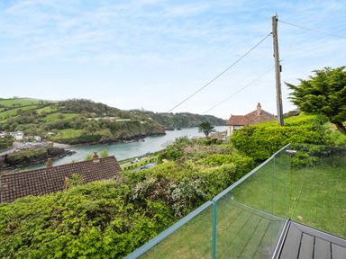A coastal view with houses trees and a body of water bordered by hills at Beach View in Combe Martin