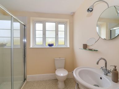 A bathroom with a toilet sink shower and a window at Canny Croft in Chilton Polden near Street