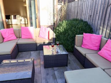 A seating area with a table and sofas at The Stables at Hall Barn Wattisfield near Walsham-Le-Willows