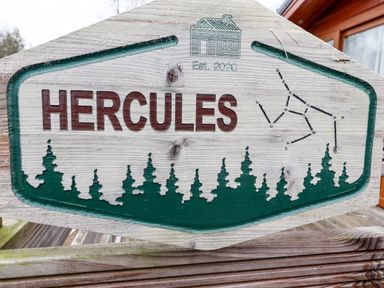 A wooden sign with the word Hercules and tree silhouettes at Hercules in Felmoor Park
