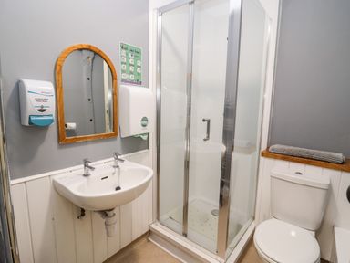A bathroom with a sink a shower cubicle and a toilet at Wick Court Farm in Arlingham near Frampton On Severn