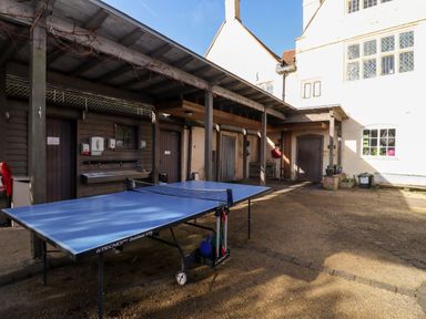 An outdoor area with a blue ping pong table under a wooden shelter at Wick Court Farm Arlingham near Frampton On Severn