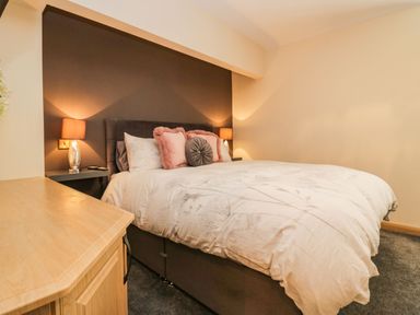 A bedroom with a bed with pillows and bedside lamps at The Anvil in Broughton-In-Furness