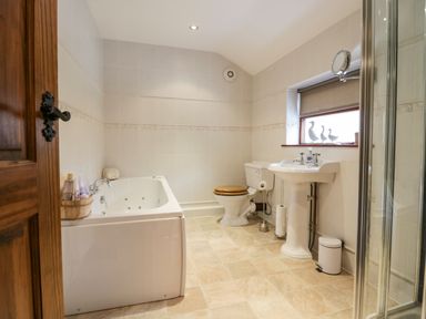 A bathroom with a bathtub toilet sink and shower at The Anvil in Broughton-In-Furness