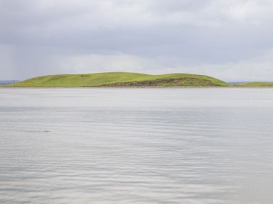 A body of water with a grassy hill in the background at Cloughoge House Kilrush County Clare