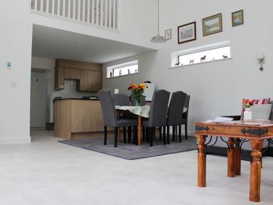 A dining room with a table and chairs at Narracott Down in South Molton