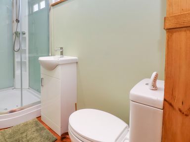 A bathroom with a shower, toilet, and sink at Lodge 1 in York