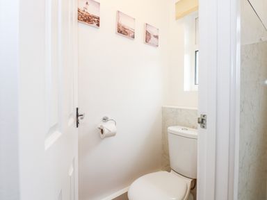 A small bathroom with a toilet paper holder and toilet at 8 Royal Chalet Park in Mundesley