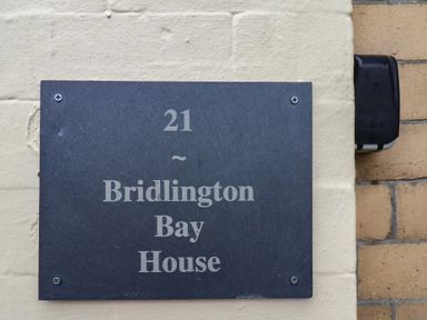 A sign displaying the address of Bridlington Bay House at Bridlington