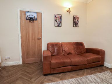 A living room with a sofa and artwork on the wall at Bridlington Bay House in Bridlington