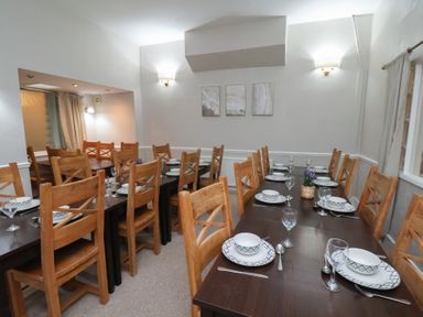 A dining room with tables and chairs at Bridlington Bay House in Bridlington