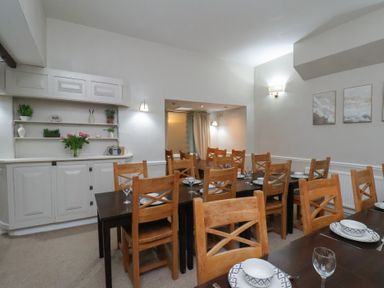 A dining room with a large table and chairs at Bridlington Bay House in Bridlington