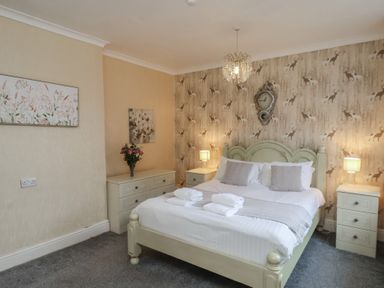 A bedroom with a bed and bedside tables at Bridlington Bay House in Bridlington