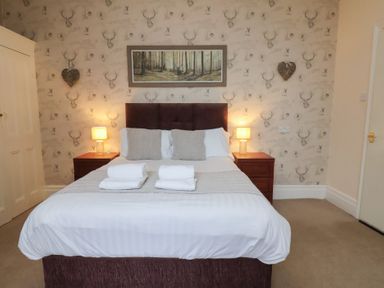 A bedroom with a bed and nightstand at Bridlington Bay House in Bridlington