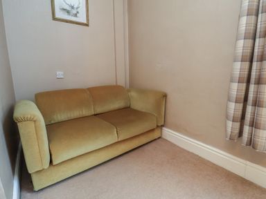 A living room with a sofa and curtains at Bridlington Bay House in Bridlington