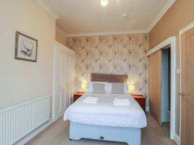 A bedroom with a bed and side tables at Bridlington Bay House in Bridlington