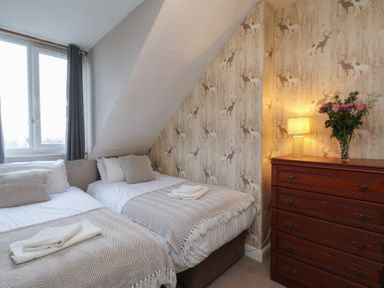 A bedroom with two beds and a dresser at Bridlington Bay House in Bridlington