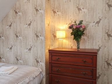 A bedroom with a chest of drawers and a lamp at Bridlington Bay House in Bridlington
