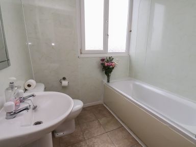 A bathroom with a sink, toilet, and bathtub at Bridlington Bay House in Bridlington