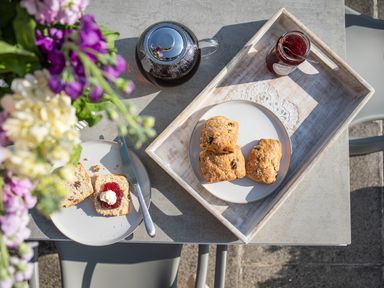 A table with scones jam and cream a jar of jam and a pot of tea at Newquay Tamarisk Lodge on the Gannel Newquay