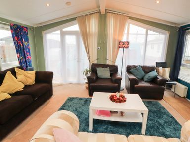 A snug with seating and a coffee table at Rosie's Zen Den in High Hesket near Armathwaite