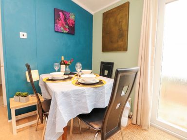 A dining room with a table set for meals at Rosie's Zen Den High Hesket near Armathwaite