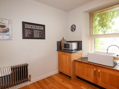 A kitchen with a sink and microwave at Sea View in St Austell