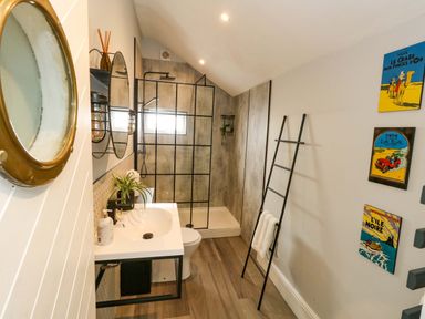 A bathroom featuring a shower, sink, and toilet at The Old Post Office in Weymouth