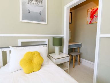A bedroom with a bed and a desk at The Old Post Office in Weymouth