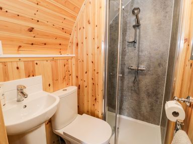 A bathroom with a sink toilet and corner shower at Conwy Pod in Capel Garmon near Betws-Y-Coed