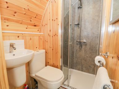 A small bathroom with a toilet sink and shower at Llugwy Pod in Capel Garmon near Betws-Y-Coed