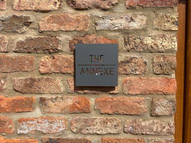 A metal sign with the text The Annexe on a brick wall at The Annexe in Bridlington
