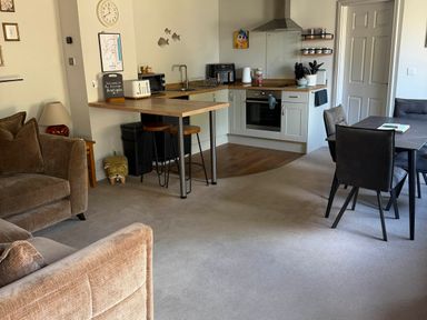 A living room with a kitchen area at The Annexe Bridlington