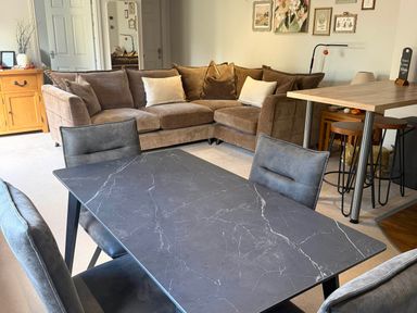 A living room with a sofa and dining table at The Annexe in Bridlington