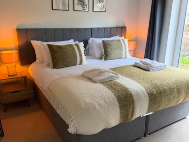 A bedroom with a bed and bedside table at The Annexe Bridlington