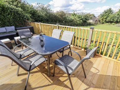 An outdoor dining area with a table and chairs at Church View in Withernwick near Aldbrough